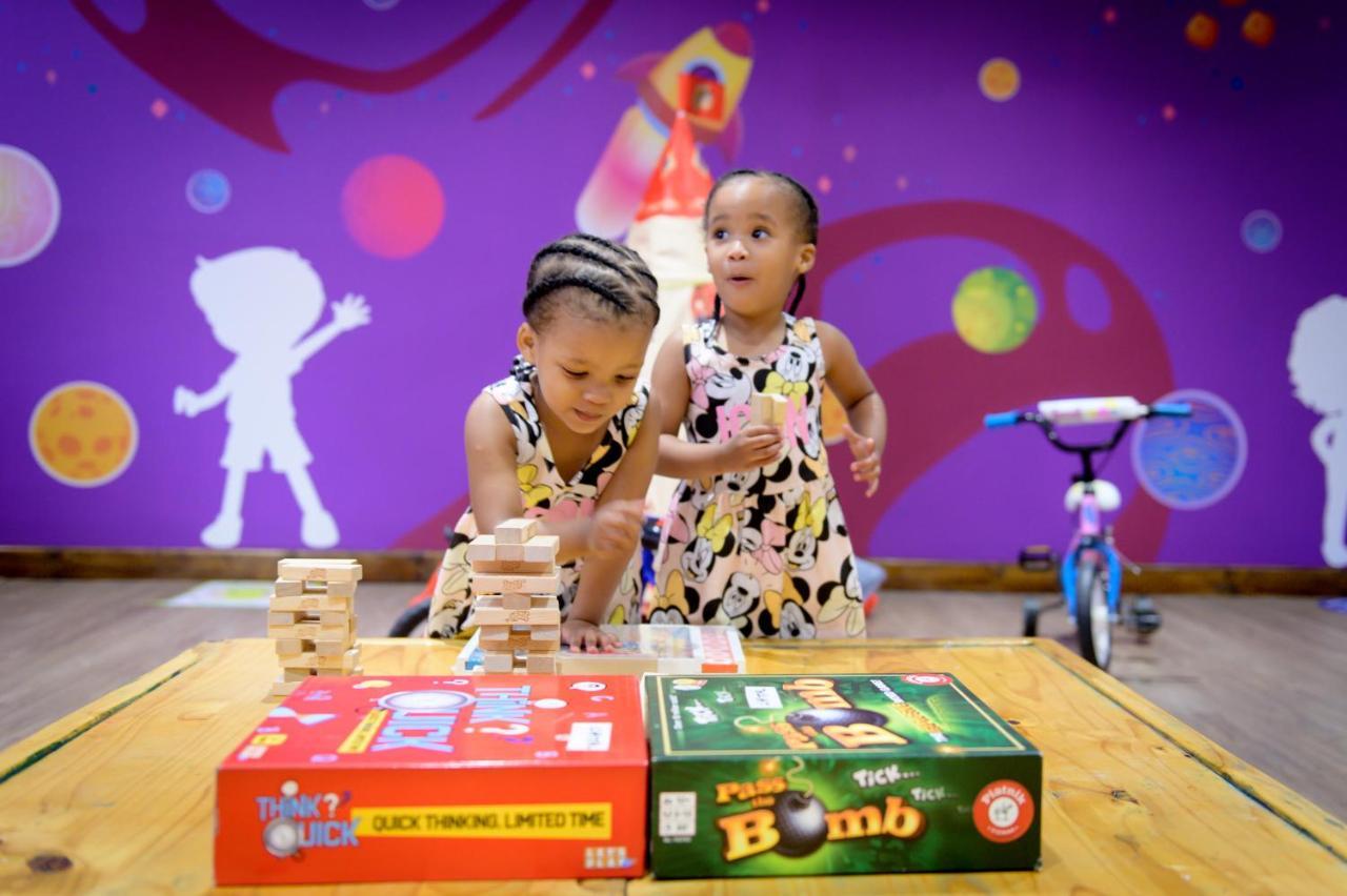 Hotel The Capital Zimbali Ballito Exterior foto Two children playing with board games
